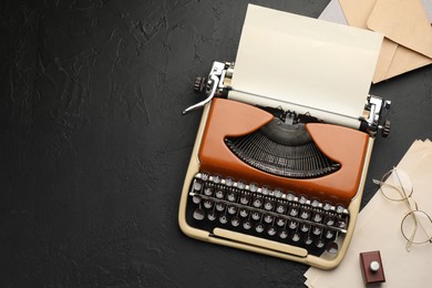 Photo of Flat lay composition with vintage typewriter on black background. Space for text