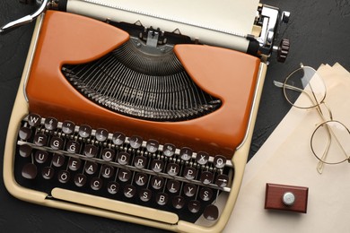Photo of Flat lay composition with vintage typewriter on black background