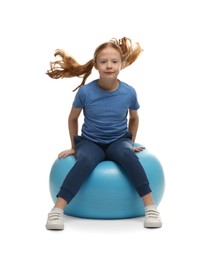 Photo of Cute little girl sitting on fitness ball against white background