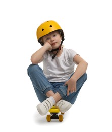 Photo of Little girl in helmet sitting on penny board against white background