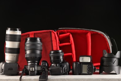 Professional photographer's equipment and backpack on light table