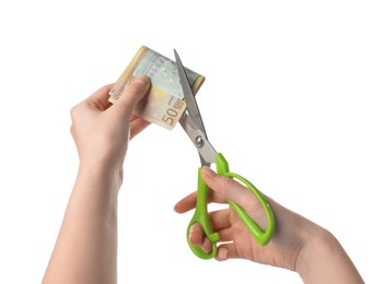 Woman cutting euro banknotes on white background, closeup