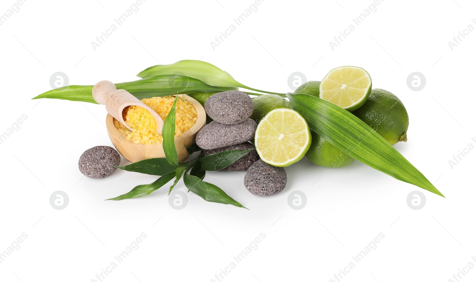Spa composition with limes, massage stones, sea salt and green leaves isolated on white Photo of Spa composition with limes, massage stones, sea salt and green leaves isolated on white