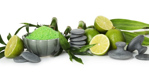 Photo of Spa composition with fresh limes, sea salt, massage stones and bamboo isolated on white