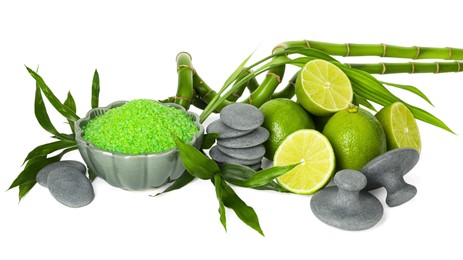 Photo of Spa composition with fresh limes, sea salt, massage stones and bamboo isolated on white