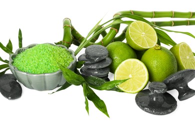 Photo of Spa composition with fresh limes, sea salt, massage stones and bamboo isolated on white