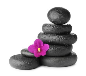 Photo of Stacked spa stones and beautiful flower isolated on white