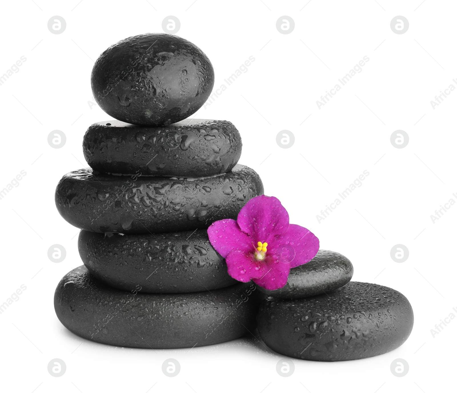 Photo of Stacked spa stones and beautiful flower isolated on white