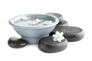 Photo of Wet spa stones and bowl of water with beautiful flowers isolated on white