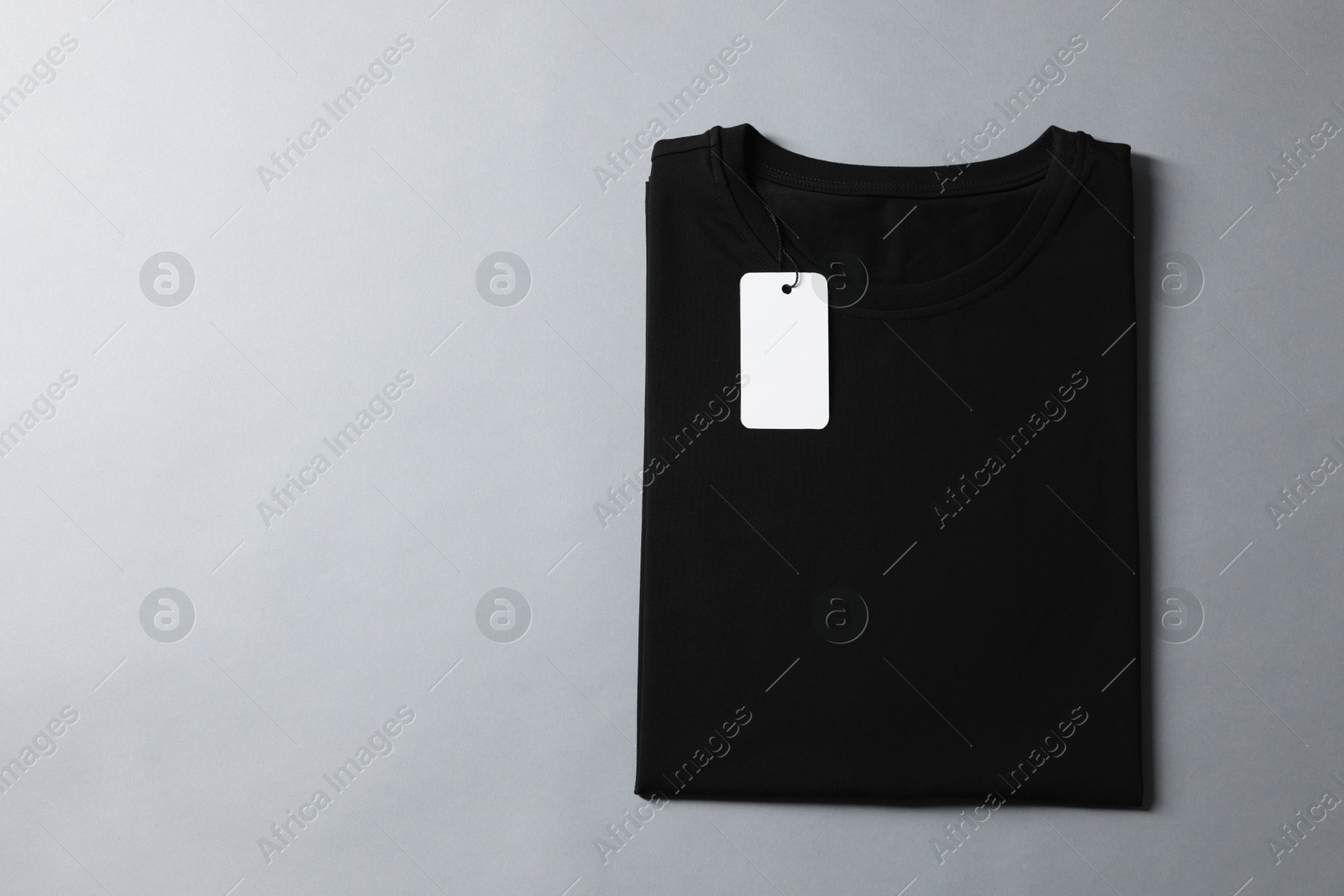 Photo of Blank black t-shirt on grey background, top view. Mockup for design