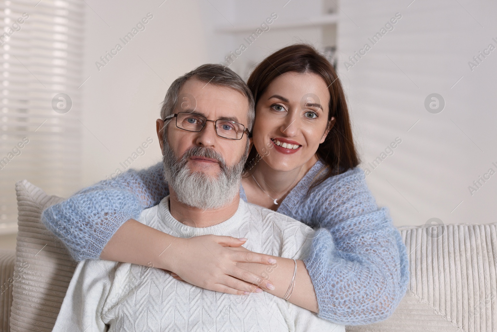 Photo of Family portrait of happy adult daughter and her father at home