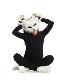 Photo of Quadrobics. Girl wearing cat mask, tail and gloves on white background