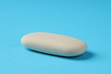 One eraser on light blue background, closeup