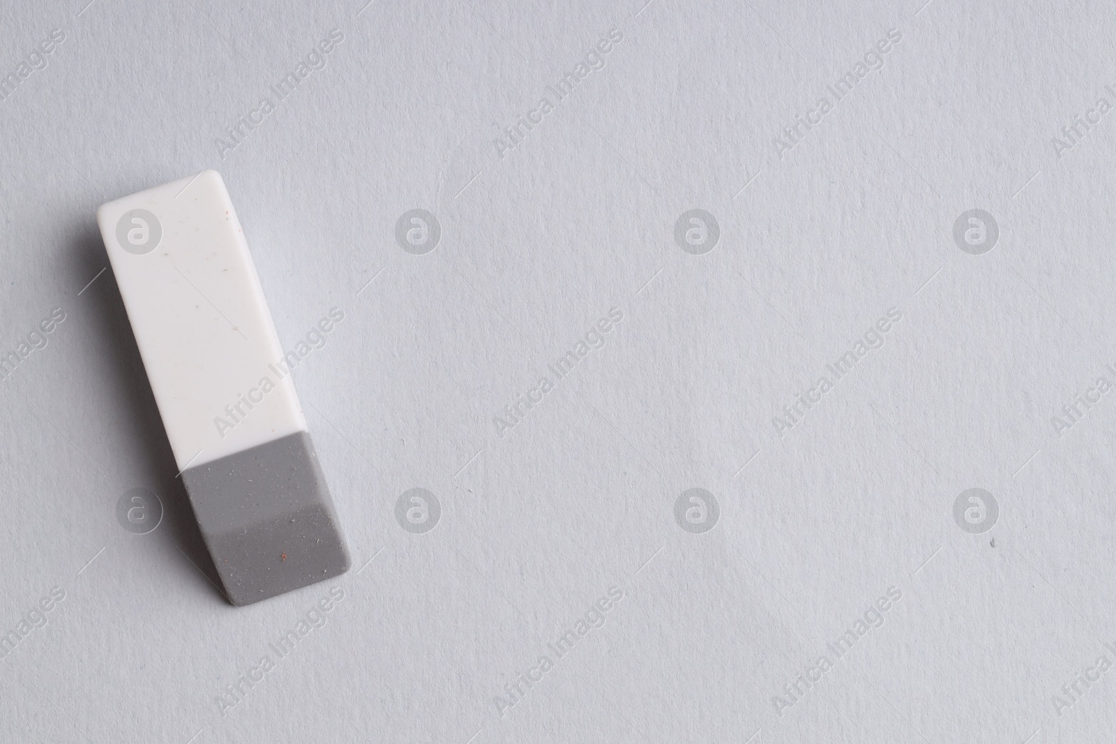 Photo of One eraser on grey background, top view. Space for text