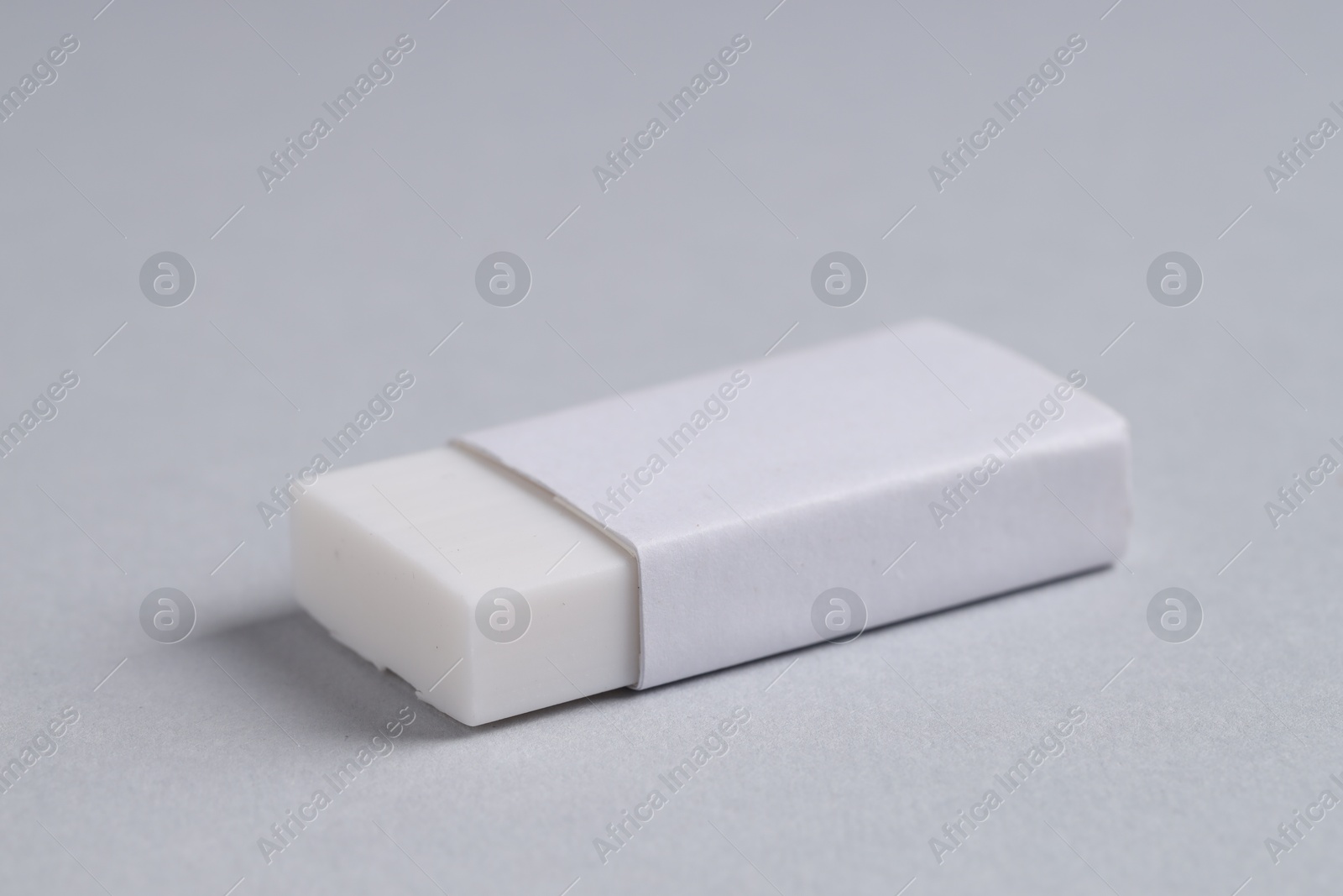 Photo of One eraser on grey background, closeup view