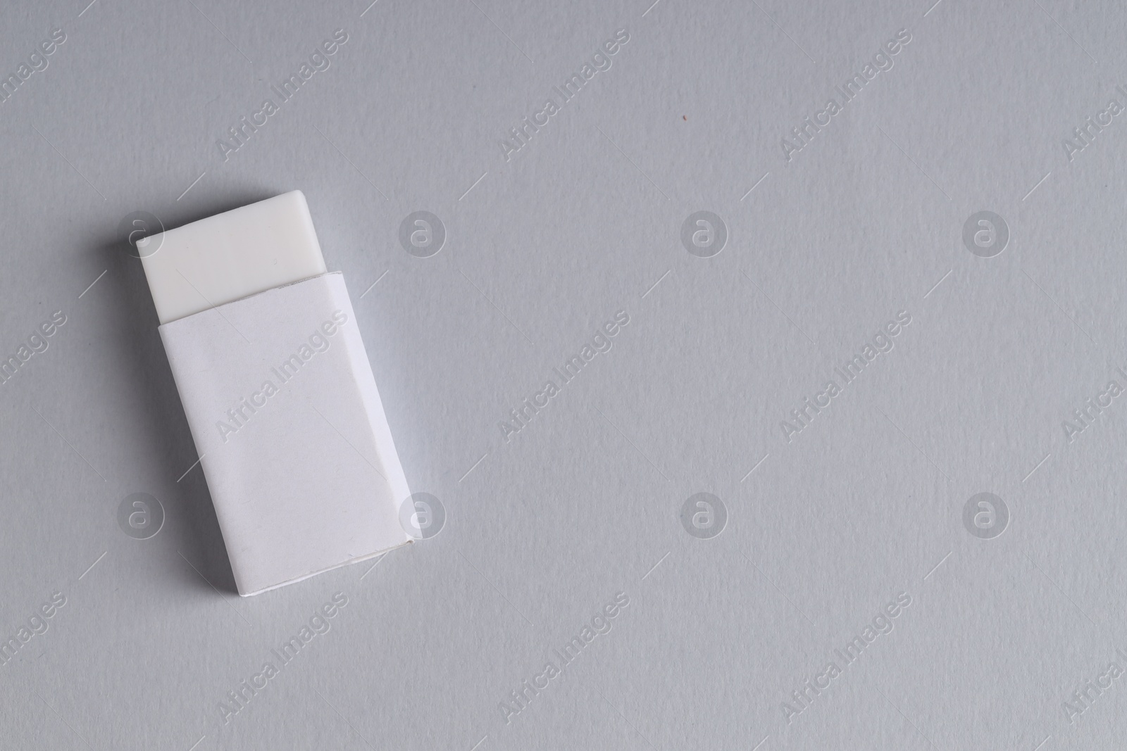 Photo of One eraser on grey background, top view. Space for text