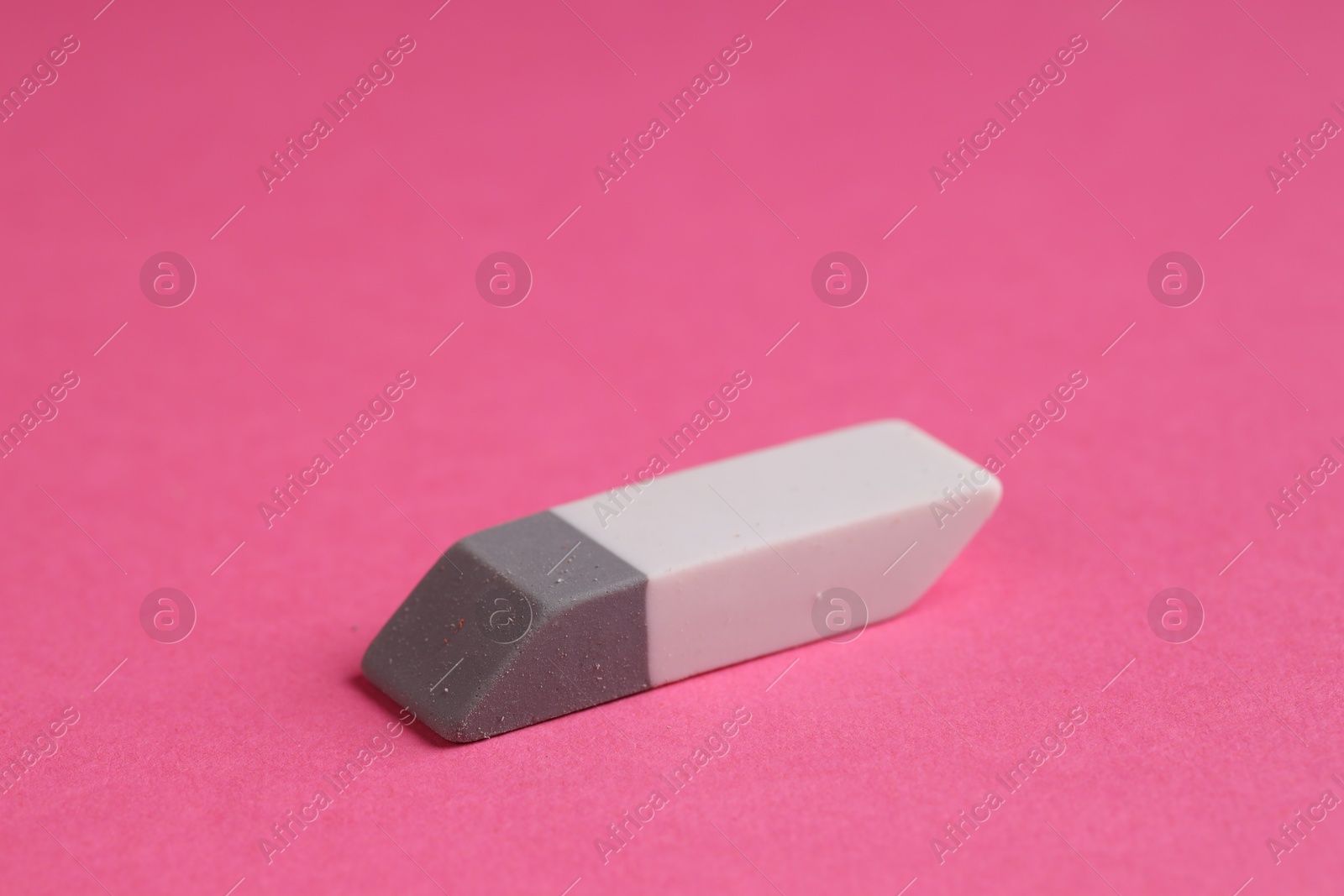 Photo of One eraser on pink background, closeup view