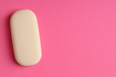 Photo of One eraser on pink background, top view. Space for text