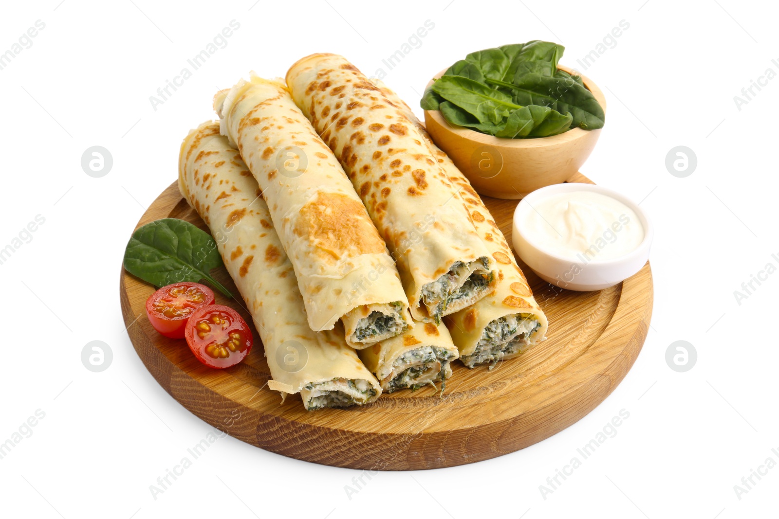 Photo of Tasty rolled crepes with cottage cheese, spinach and tomato isolated on white