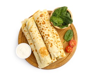 Photo of Tasty rolled crepes with cottage cheese, spinach and tomato isolated on white, top view