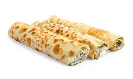 Photo of Tasty rolled crepes with cottage cheese and spinach isolated on white