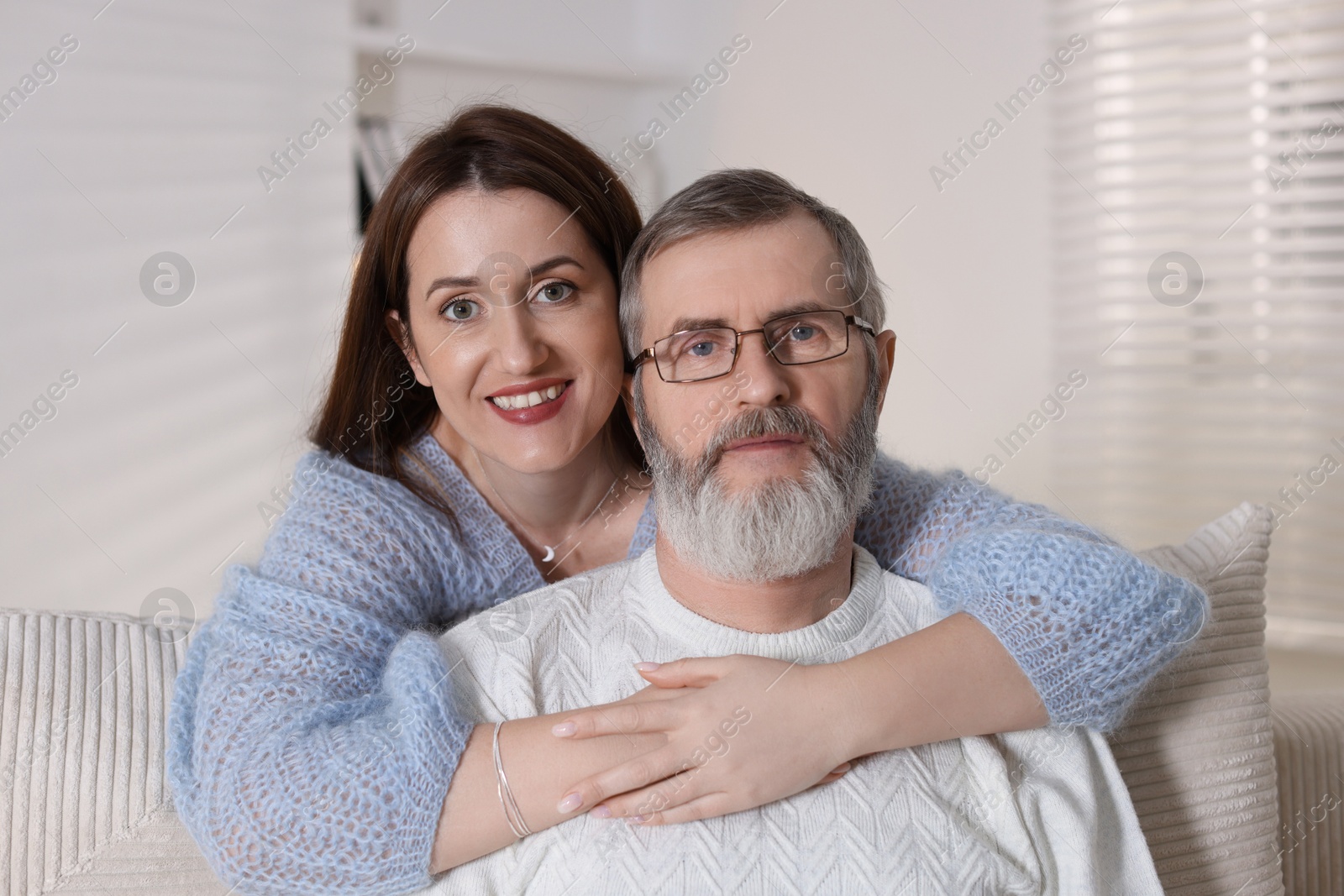 Photo of Family portrait of happy adult daughter and her father at home