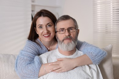 Photo of Family portrait of happy adult daughter and her father at home