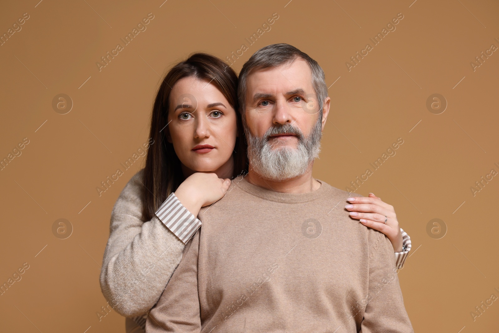 Photo of Family portrait of daughter and her father on light brown background