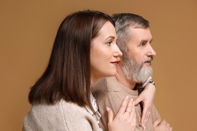 Photo of Daughter and her father on brown background