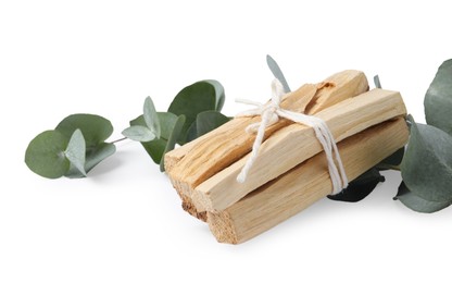 Photo of Palo santo sticks and eucalyptus branches isolated on white