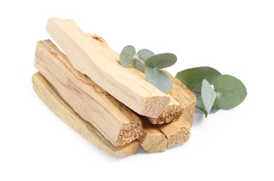 Photo of Palo santo sticks and eucalyptus leaves isolated on white