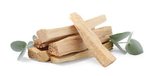 Photo of Palo santo sticks and eucalyptus leaves isolated on white