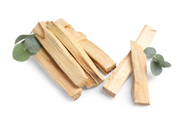 Photo of Palo santo sticks and eucalyptus leaves isolated on white