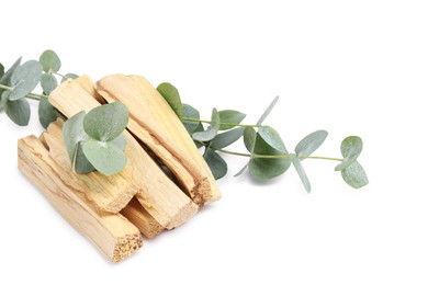 Photo of Palo santo sticks and eucalyptus branches isolated on white