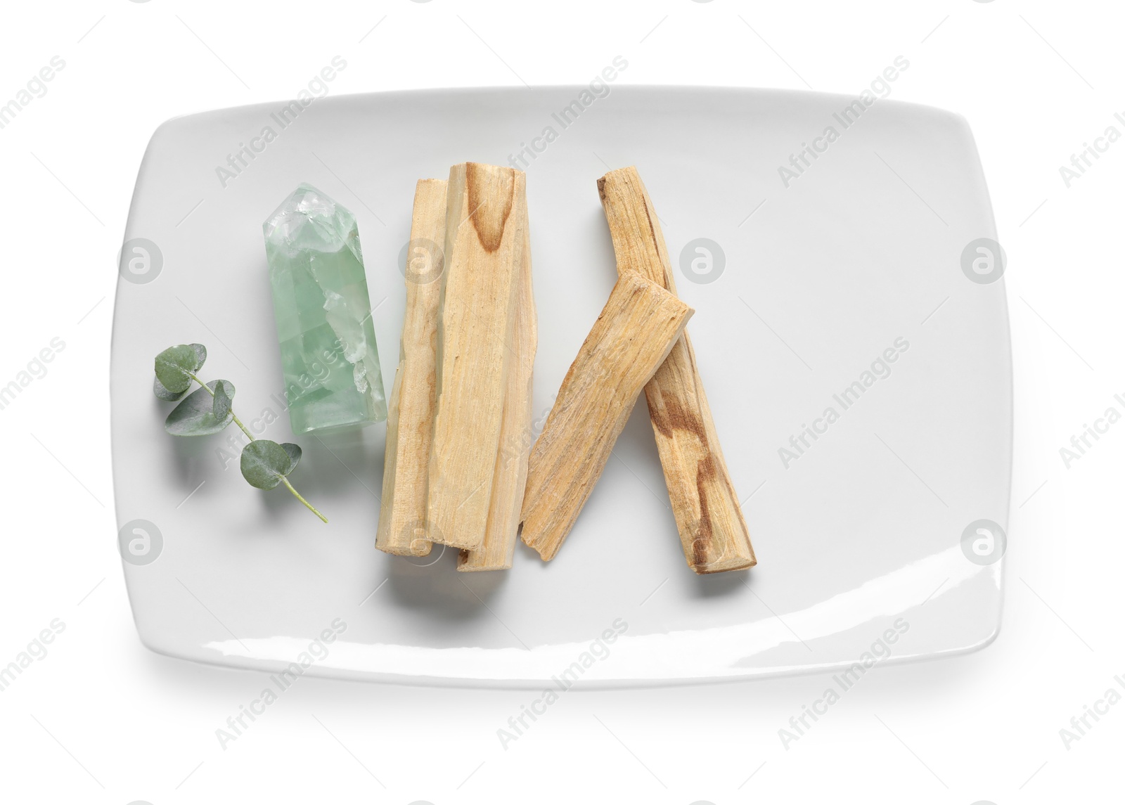 Photo of Palo santo sticks and gemstones isolated on white, top view