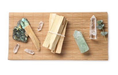 Photo of Palo santo sticks and gemstones isolated on white, top view