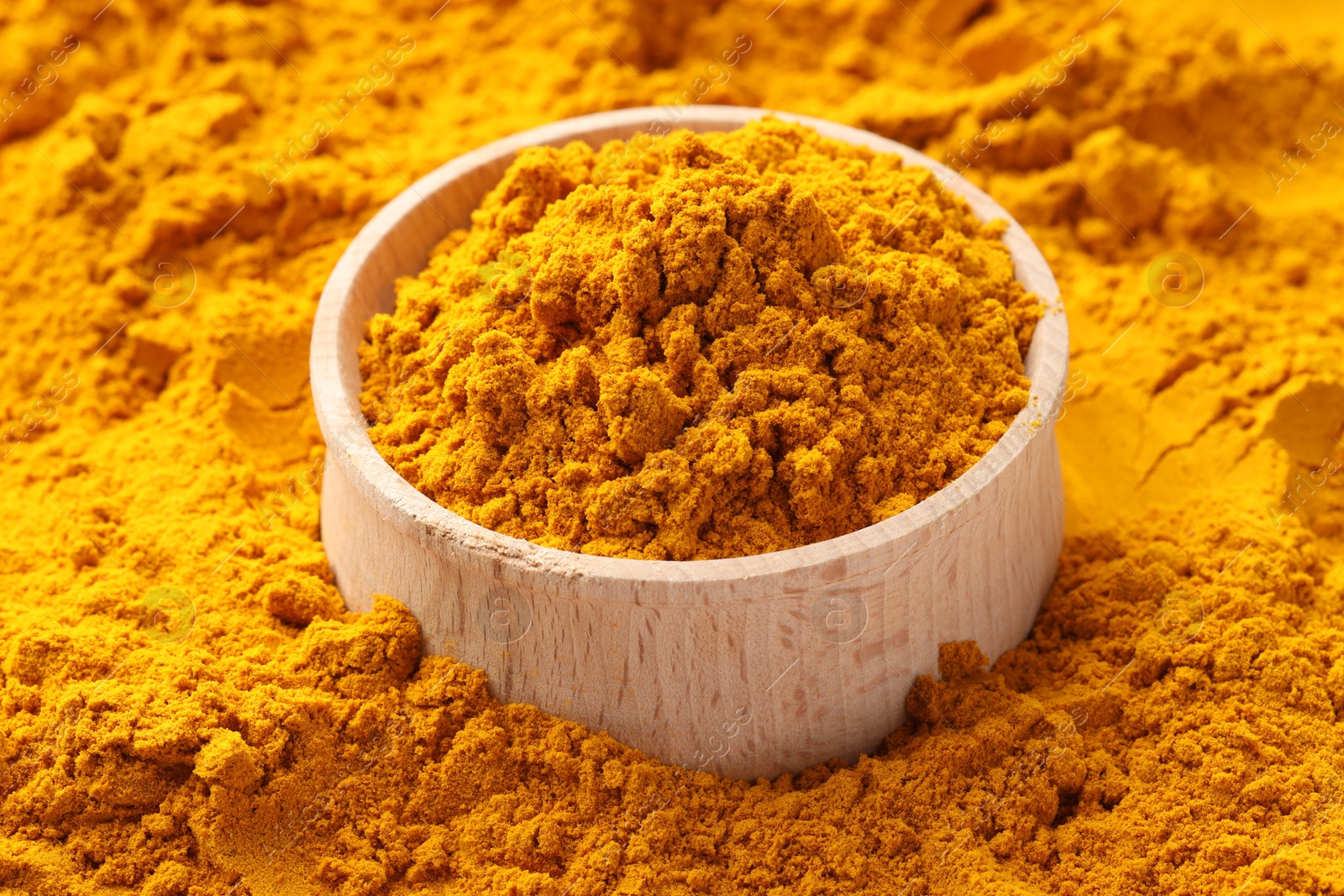 Photo of Turmeric powder in bowl on spice, closeup