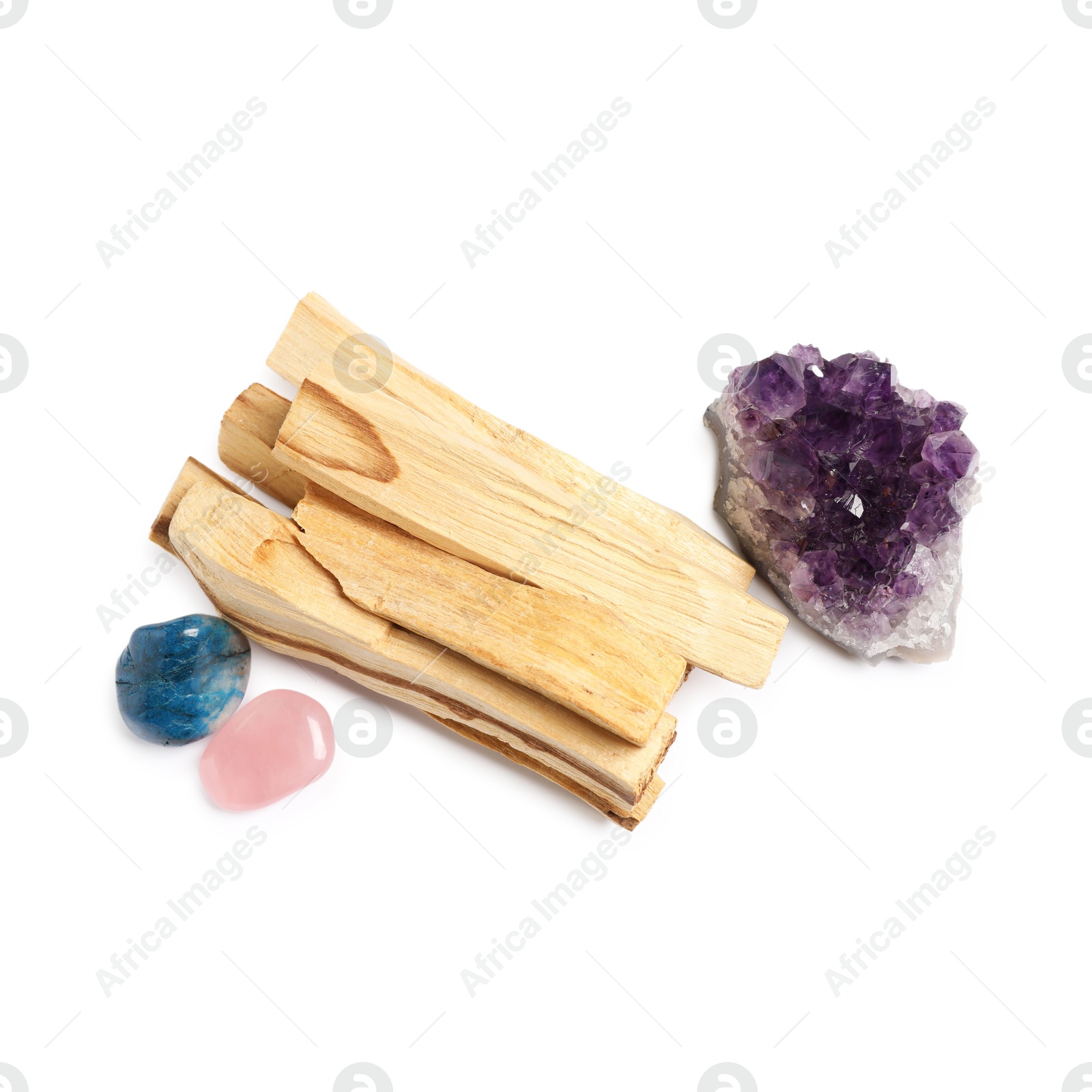 Photo of Palo santo sticks and gemstones isolated on white, top view