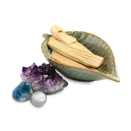 Photo of Palo santo sticks and gemstones isolated on white