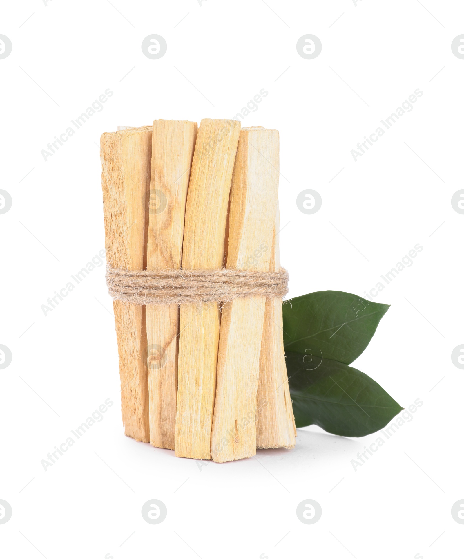 Photo of Bunch of palo santo sticks and green leaves on white background