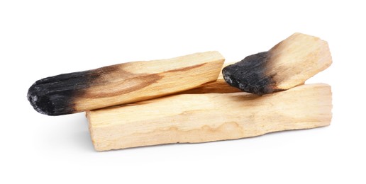 Photo of Whole and burnt palo santo sticks on white background