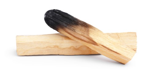 Photo of Whole palo santo stick and burnt one on white background