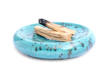 Photo of Whole palo santo stick and burnt one on white background