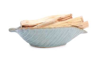 Palo santo sticks in ceramic bowl on white background