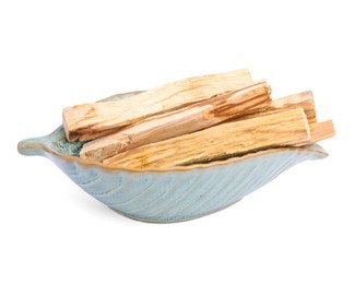 Photo of Palo santo sticks in ceramic bowl on white background