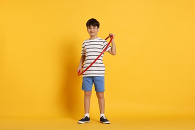 Photo of Boy with hula hoop on yellow background