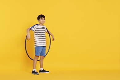 Photo of Boy with hula hoop on yellow background, space for text