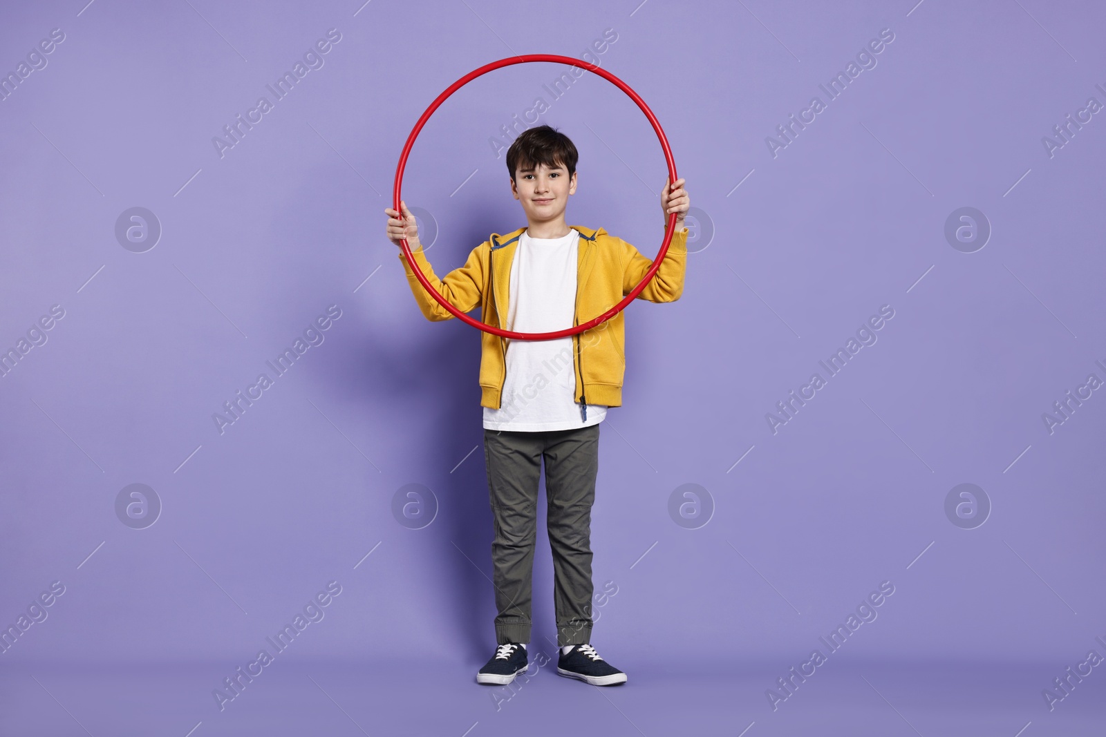 Photo of Boy with hula hoop on violet background