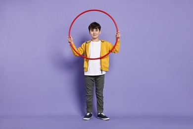 Photo of Boy with hula hoop on violet background