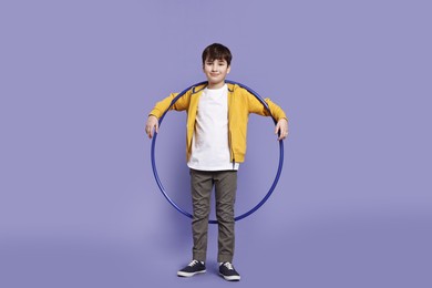 Photo of Boy with hula hoop on violet background